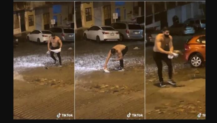 Hombre musculoso rescata a un tlacuache de la lluvia y causa sensación