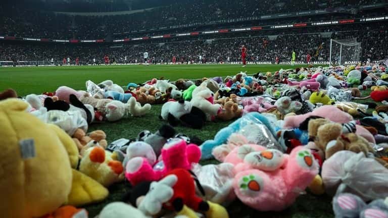 Aficionados turcos lanzan juguetes a la cancha para niños afectados por los sismos