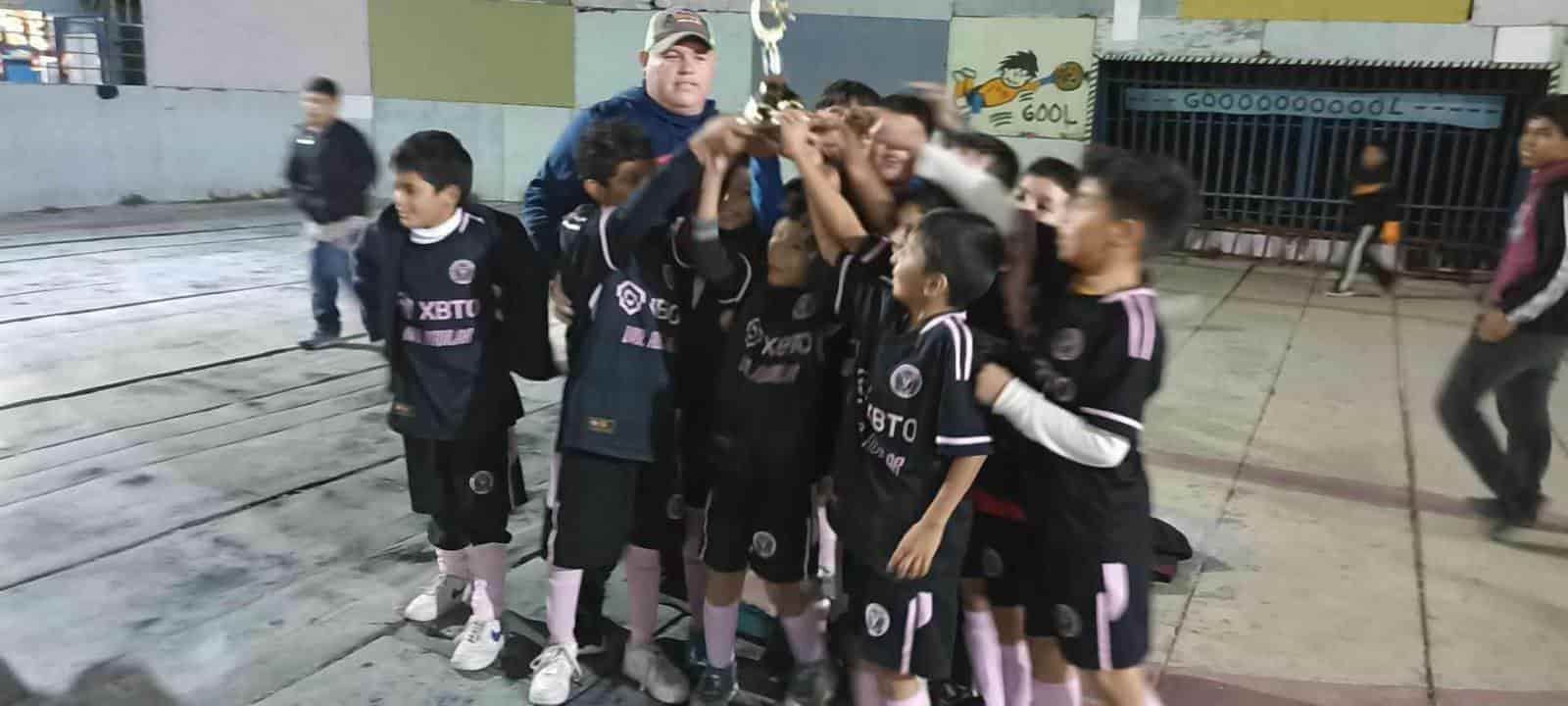 Los chicos del Deportivo Aguilar alzando el trofeo.