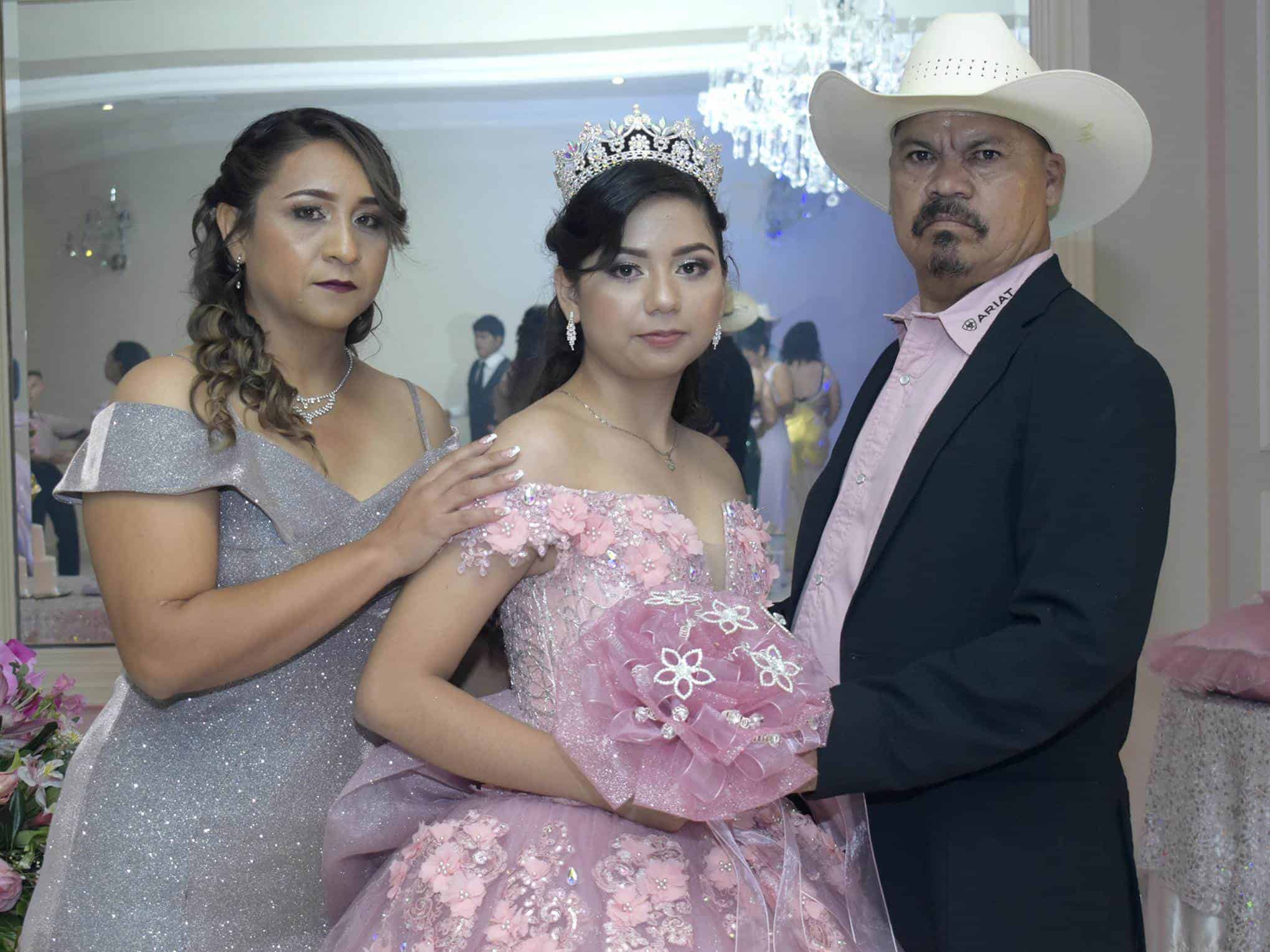 .Acompañada de sus padres.